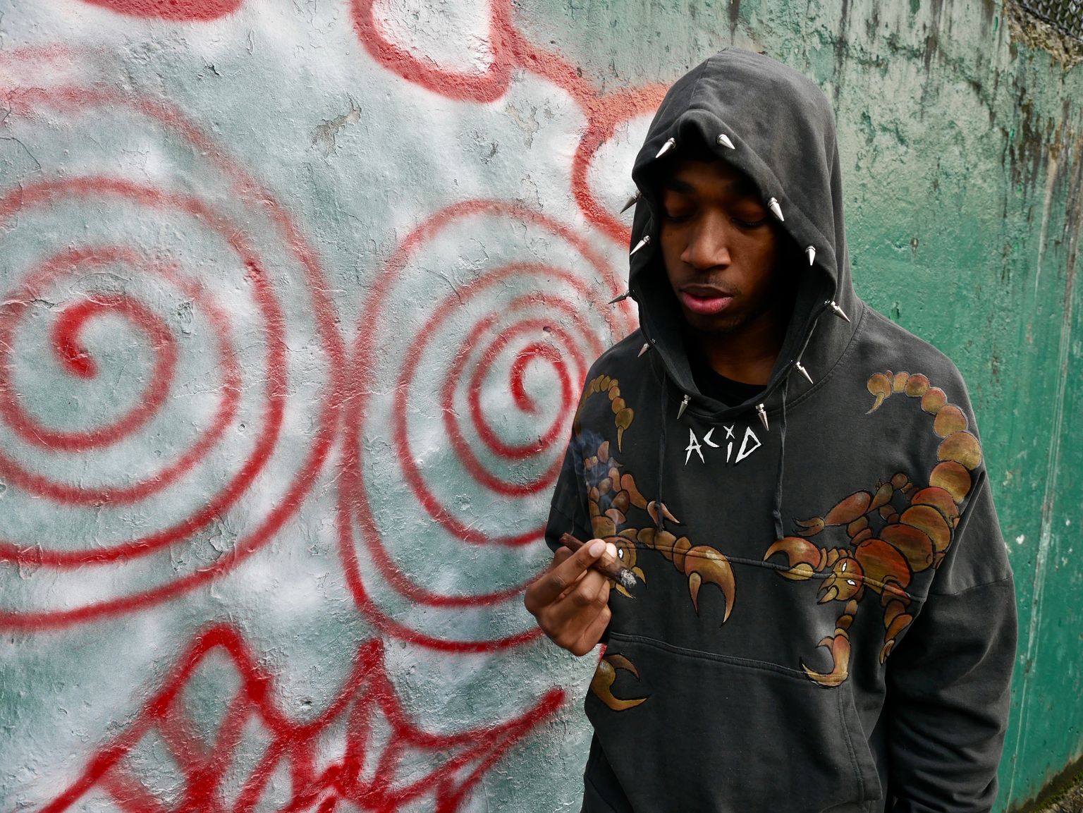 @crrksy wearing a one of a kind hand painted ACiD scorpion hoodie